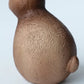 Close-up of a textured brown object on a light blue background