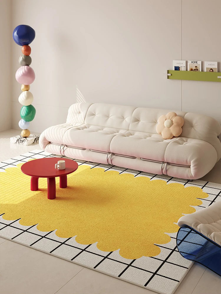 Modern living room with a yellow rug, white sofa, and colorful decor.