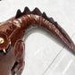 Brown crocodile-patterned handbag on a white background