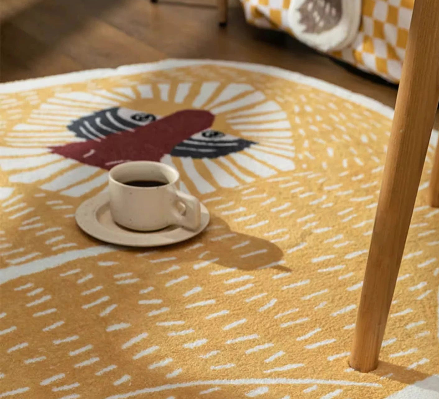 Yellow rug with a rooster design featuring a cup of coffee on a wooden floor.