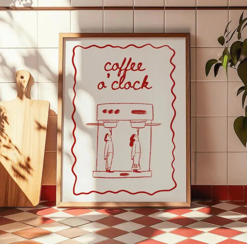 Framed artwork with 'coffee a clock' text and espresso machine illustration on a tiled wall.