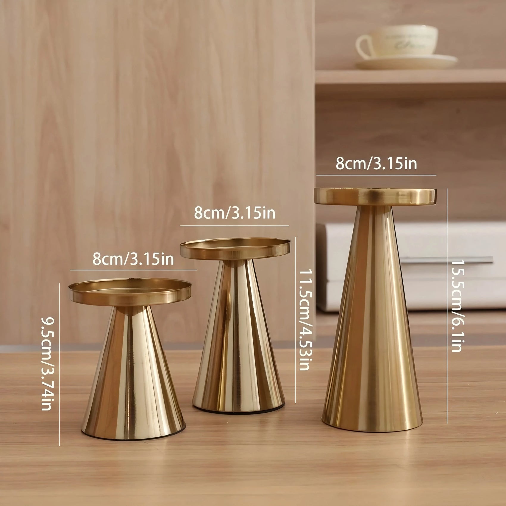 Three gold stools of different sizes with measurements on a wooden surface.