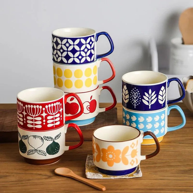 Set of colorful mugs with various patterns on a wooden surface.