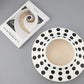 Polka dot plate with Kinfolk book on a gray background