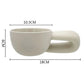 Beige ceramic cup with handle and measurements on a white background
