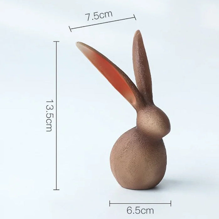 Wooden rabbit ornament with measurements on a white background