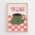 Framed artwork with a green coffee cup on a red and white checkered background and text &