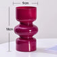 Pink vase with measurements on a white background