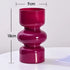 Pink vase with measurements on a white background