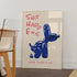Poster with blue balloon dog and red text on a wall in a room.
