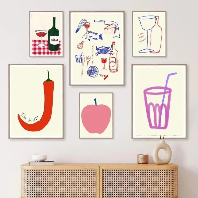 Set of colorful wall art prints on a white wall above a wooden cabinet.