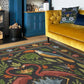 Living room with a yellow sofa, decorative rug featuring flamingos, and blue cabinets.