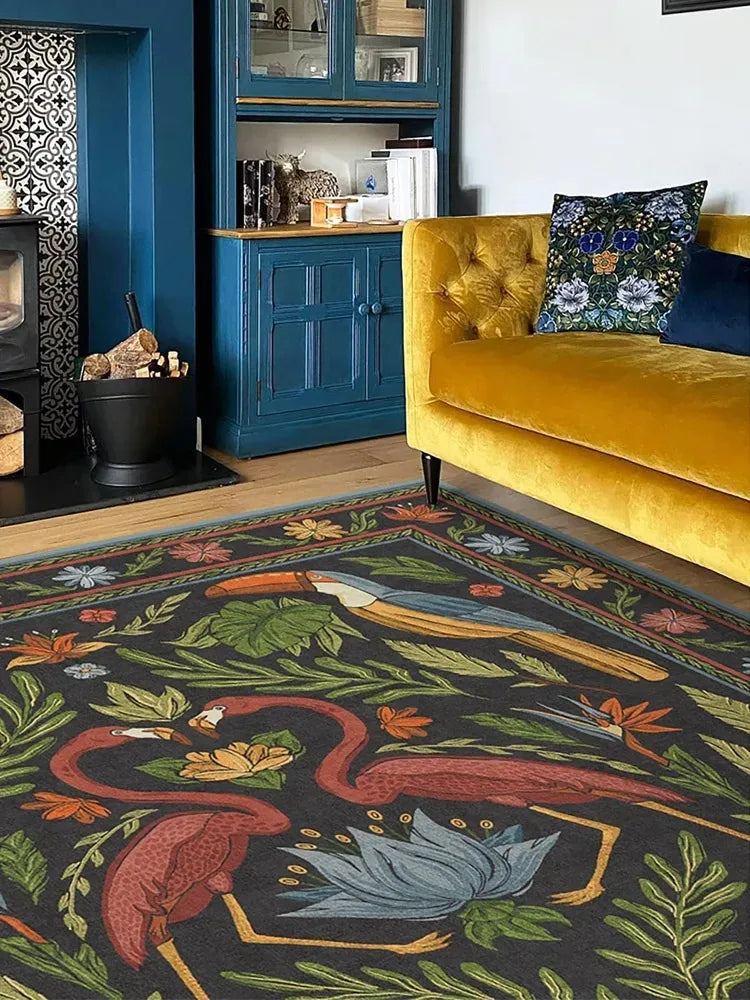 Living room with a yellow sofa, decorative rug featuring flamingos, and blue cabinets.