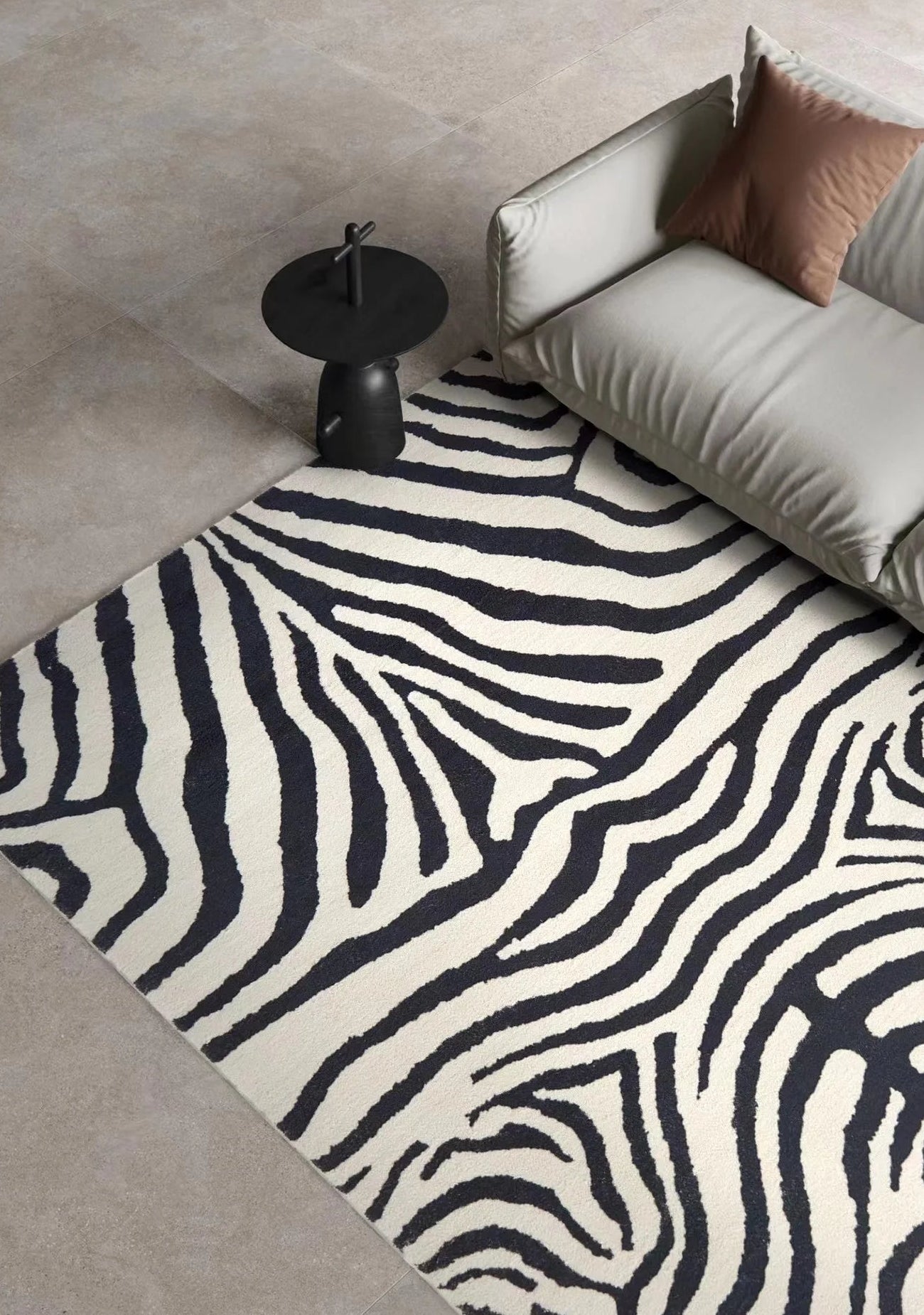 Zebra patterned rug on a beige floor with a modern sofa and side table.