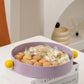 Purple bowl with snacks on a stack of books