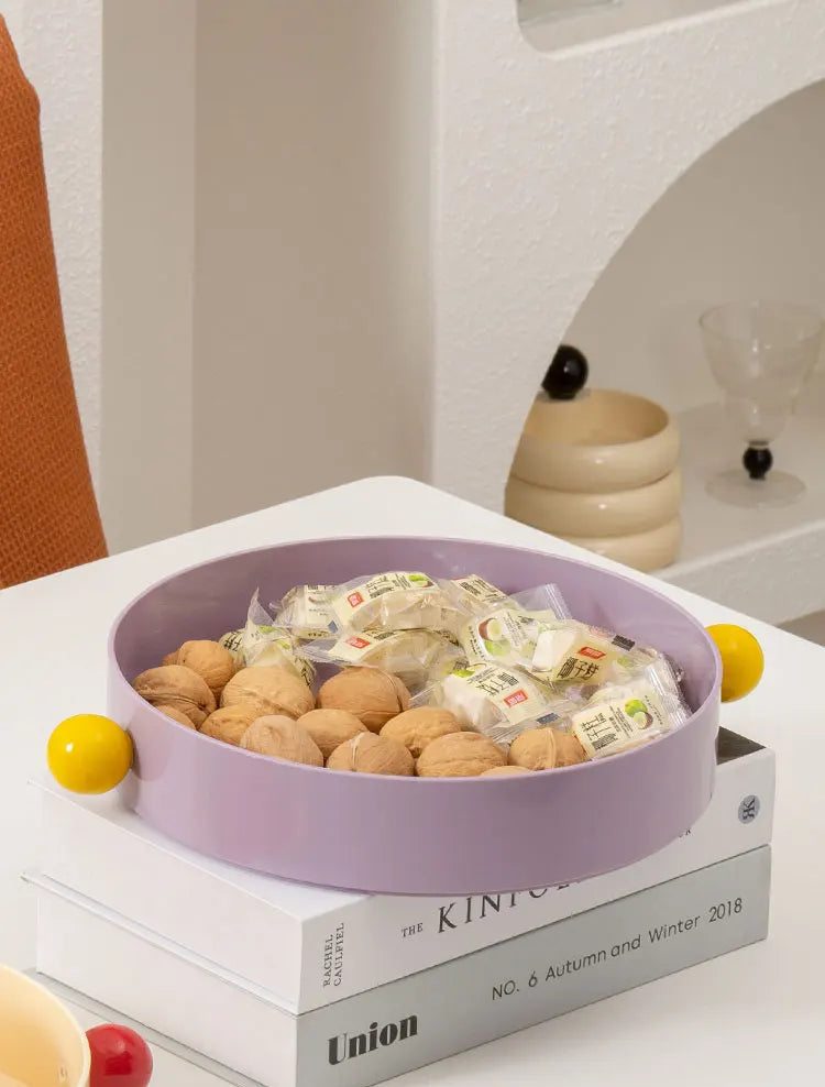 Purple bowl with snacks on a stack of books