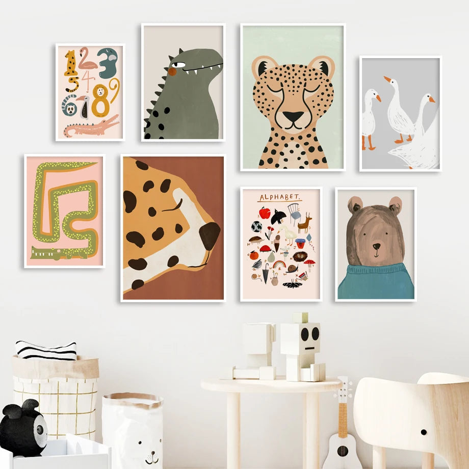 Collection of children's wall art prints on a white wall with toys below.
