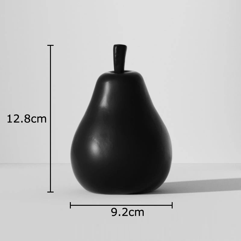Black pear-shaped object with measurements on a light gray background