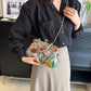 Person holding a floral clutch bag in an indoor setting