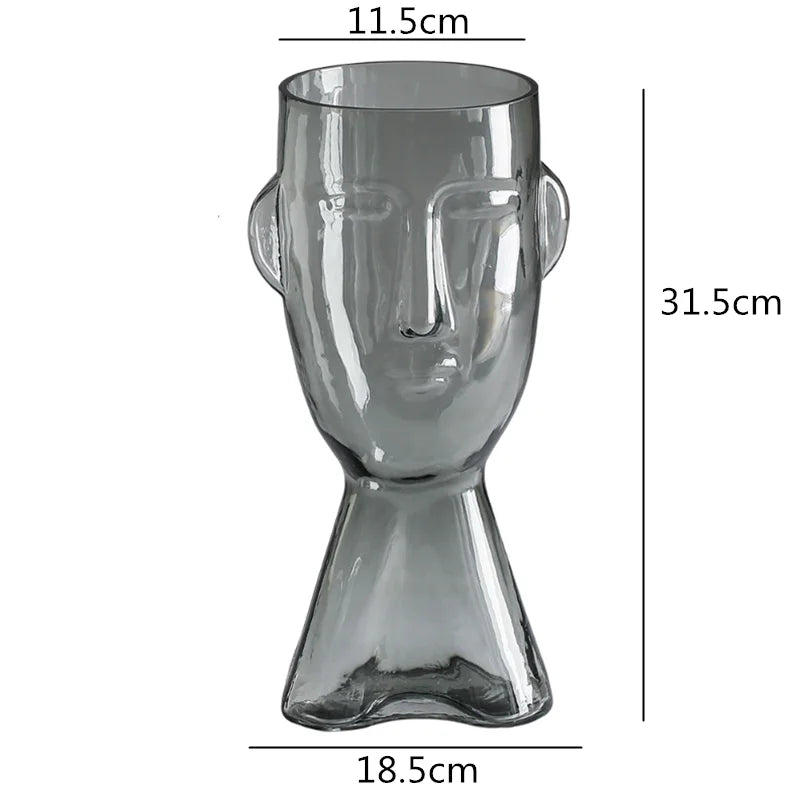 Clear glass vase shaped like a face with dimensions labeled on a white background