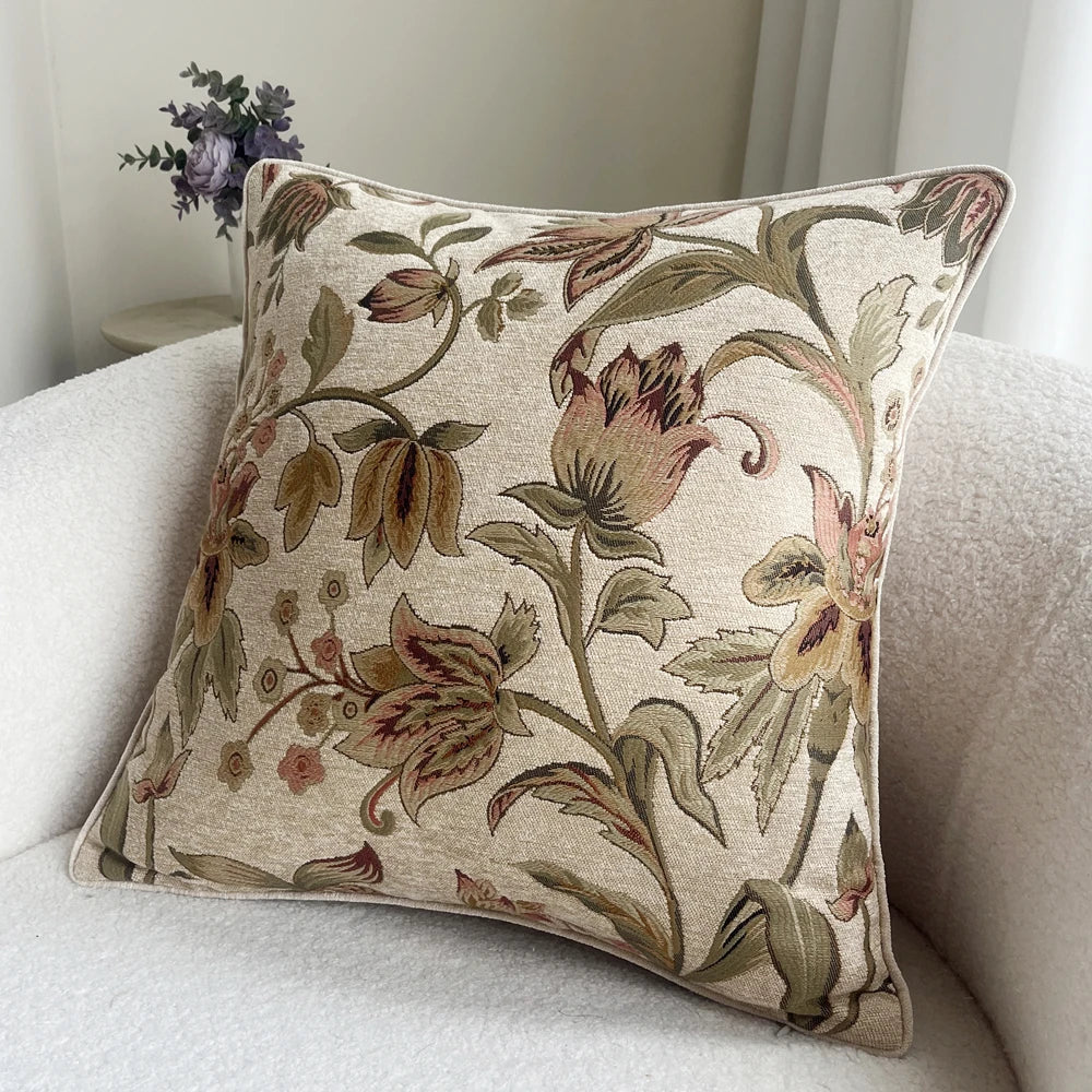 Floral patterned pillow on a sofa with a neutral background