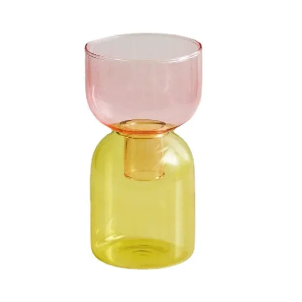 Two-toned glass vase with pink top and yellow bottom on a white background