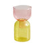 Two-toned glass vase with pink top and yellow bottom on a white background