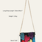 Black handbag with colorful heart designs on a white background