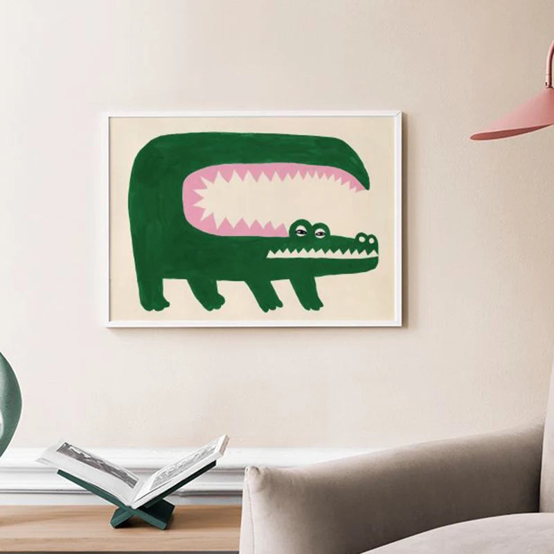 Framed illustration of a green alligator with a pink mouth on a beige wall.