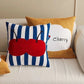 Decorative pillows with cherry design on a sofa