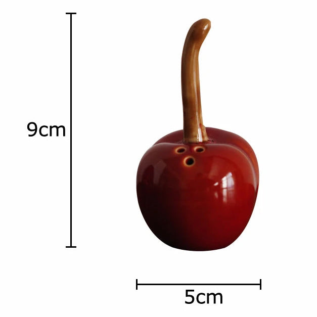 Red apple-shaped container with wooden handle and measurements on a white background