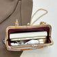 Gold clutch bag with chain strap on a white background