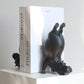 Hippopotamus-shaped bookends on a white surface with a white box labeled 'FOLIO-02' in the background.