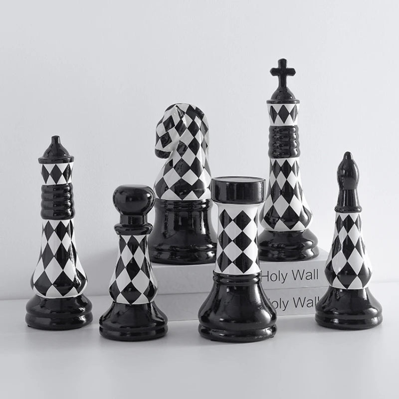 Set of black and white checkered chess pieces on a light gray background