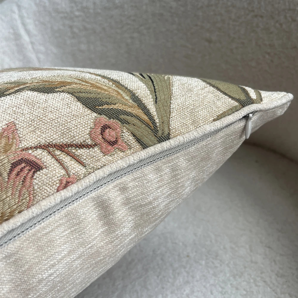 Decorative pillow with floral embroidery on a neutral background
