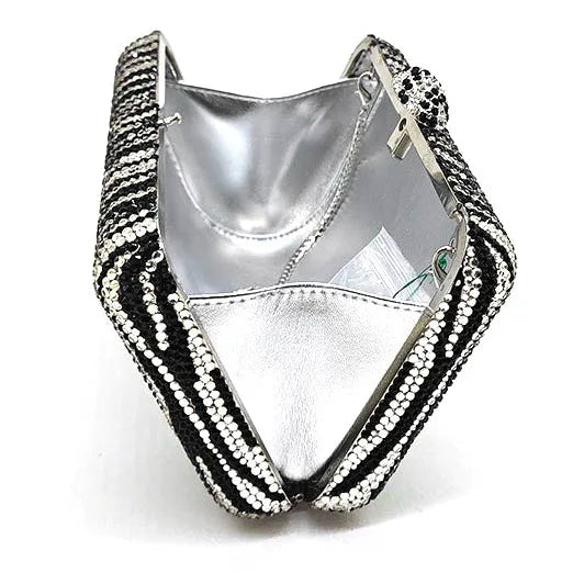 Silver clutch with black and white patterned strap on a white background