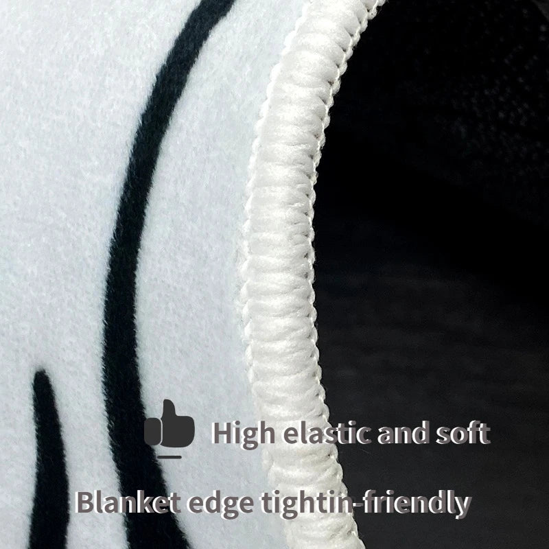 Close-up of a blanket edge with text indicating high elasticity and softness.