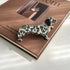 Decorative dalmatian dog figurine on a brown surface with text