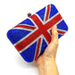 Hand holding a clutch bag with Union Jack design on a white background