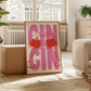 Framed artwork with 'GIN GIN' text and red drink glasses in a living room setting.