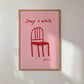 Framed artwork with a red chair illustration and text on a pink background