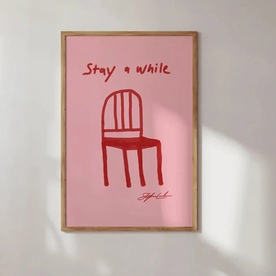 Framed artwork with a red chair illustration and text on a pink background