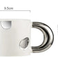 White ceramic mug with decorative handle and spoon, featuring measurements on a white background.