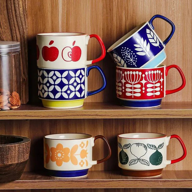 Set of colorful mugs with patterns on a wooden shelf