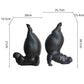 Two black hippo figurines with measurements on a white background