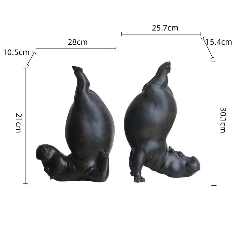 Two black hippo figurines with measurements on a white background