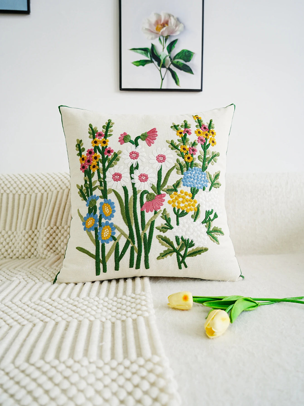 Decorative pillow with floral embroidery on a white couch
