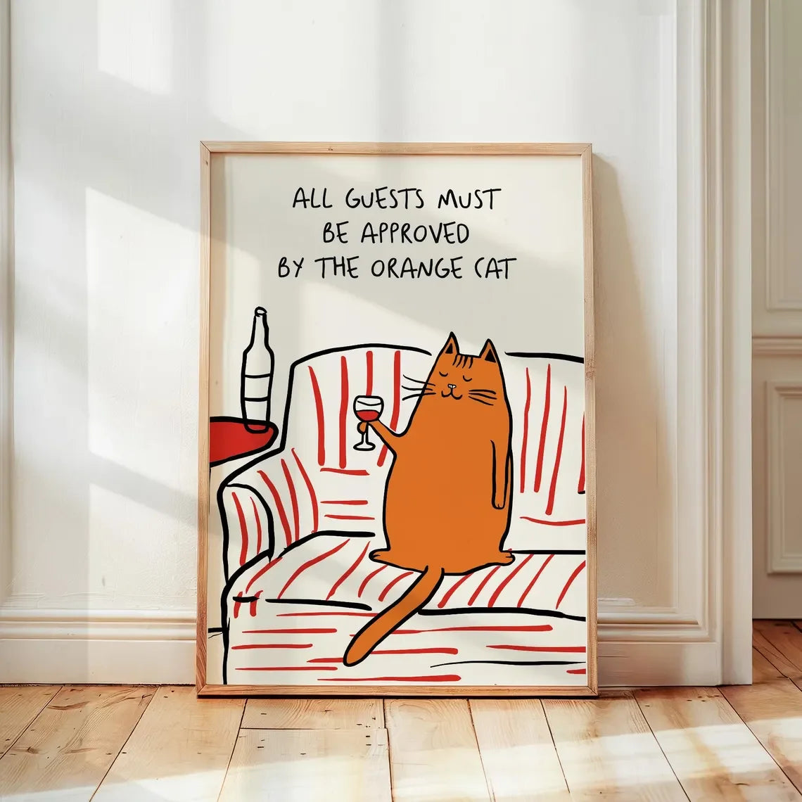 Framed artwork with a cat illustration and text on a white wall.