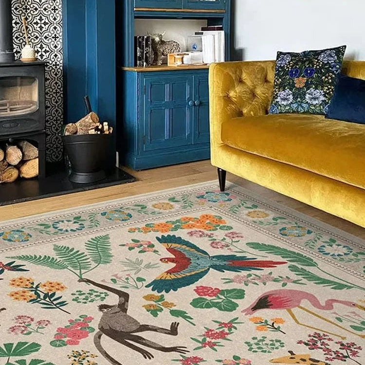 Living room with a colorful rug featuring animals and plants, a yellow couch, and a blue cabinet.