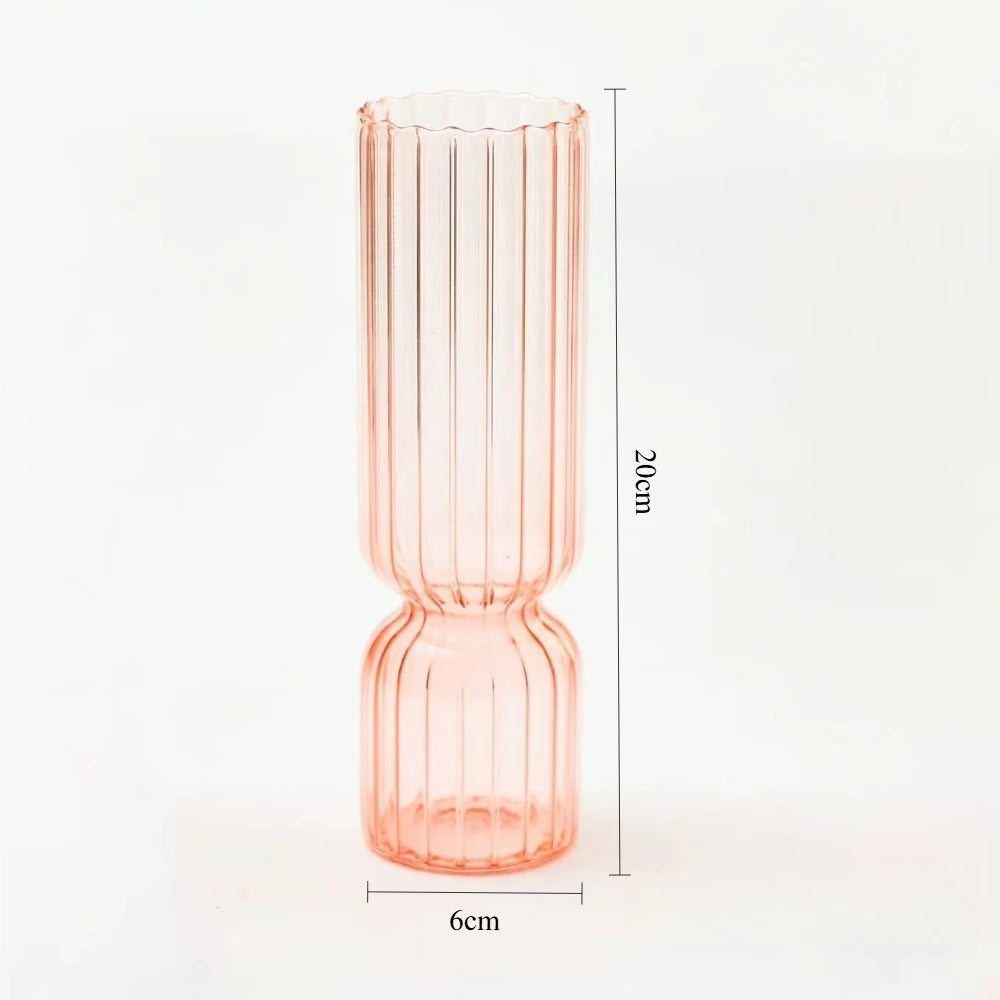 Pink glass vase with measurements on a white background